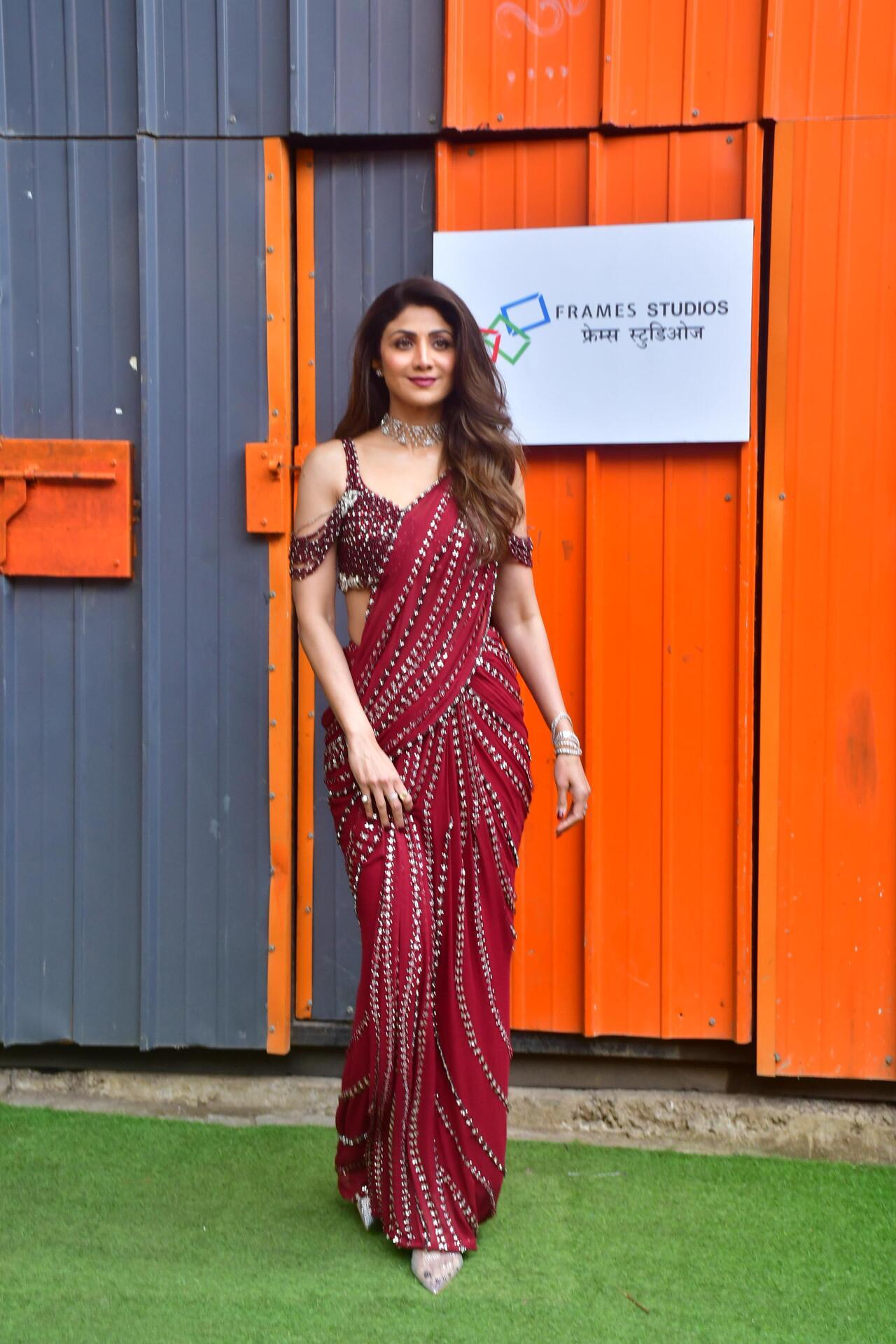 Shilpa Shetty was clicked on the sets of Super Dancer where she looked ravishing in red mirror-work saree. The actress looked stunning as she paired it with minimal jewellery. 